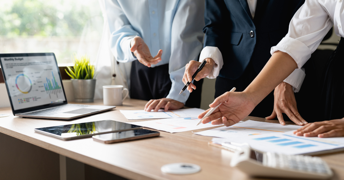 Image of a group of colleagues analysing growth reports of the company
